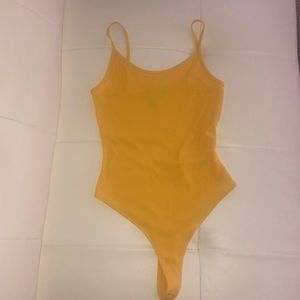 Bright yellow bodysuit